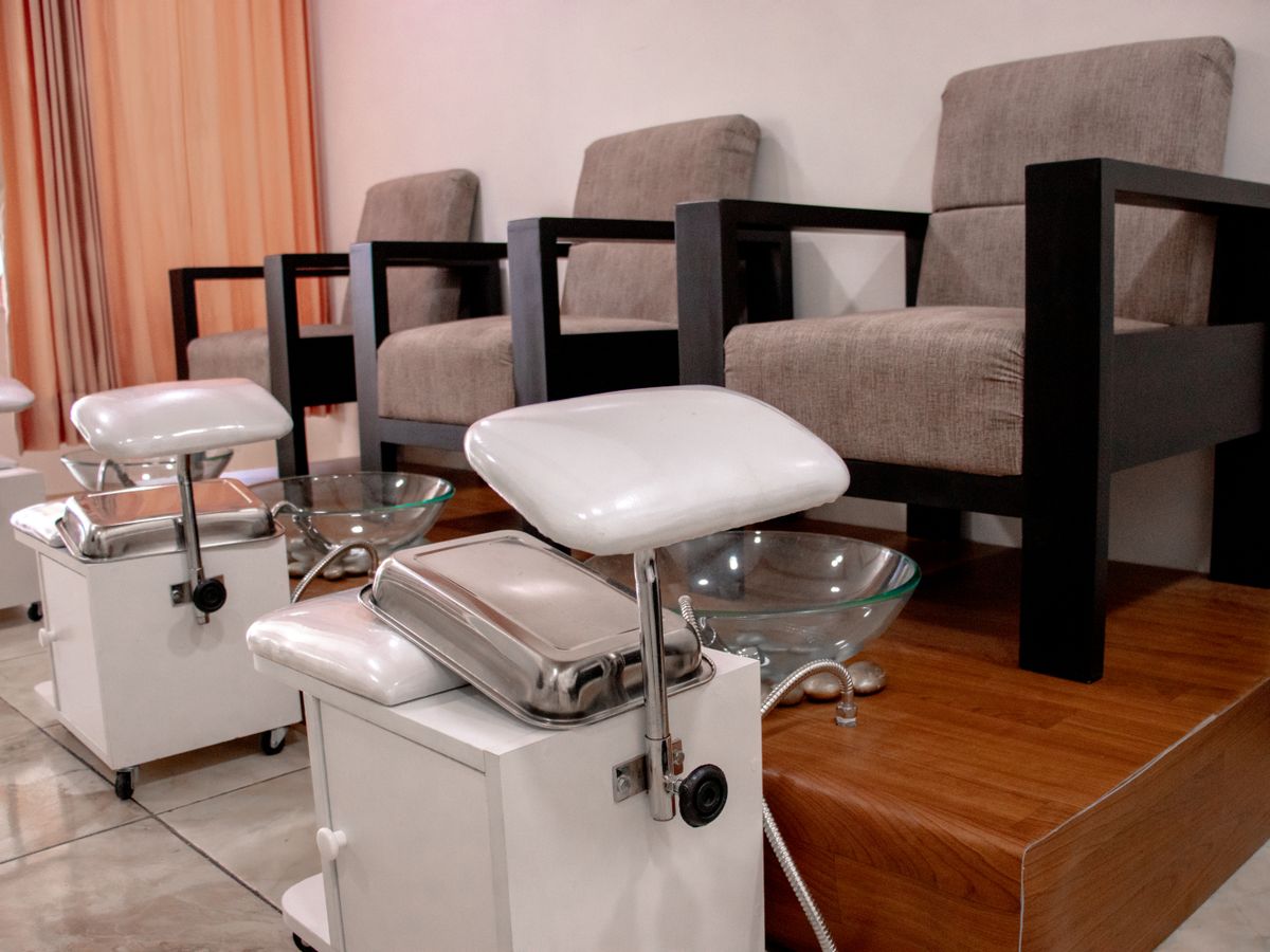 A calm, premium salon setting with a technician at work.
